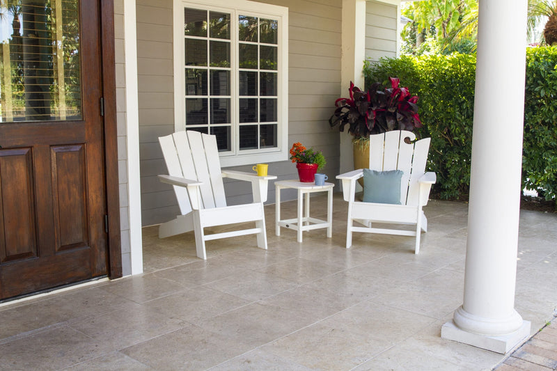 A POLYWOOD Wave Collection 3 Piece Set in White is arranged on a porch with a potted plant.